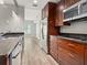 Modern kitchen with stainless steel appliances and wood cabinets at 100 S Eola Dr # 608, Orlando, FL 32801