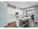 Open kitchen featuring white cabinets, a center island with seating, and a light-filled breakfast nook at 1920 Lobelia Dr., Lake Mary, FL 32746