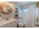 Bright bathroom with a decorative mirror and a shower-tub combination at 3076 Crane Strand Dr, Winter Park, FL 32792