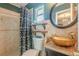 Stylish bathroom featuring a decorative sink, floating shelves, and shower with patterned curtain at 3076 Crane Strand Dr, Winter Park, FL 32792