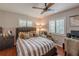 Comfortable bedroom with wood floors, stylish gray bedding, and large sunny windows at 3076 Crane Strand Dr, Winter Park, FL 32792