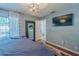 A modern bedroom with wood floors, a mounted TV, and a decorative light fixture at 3076 Crane Strand Dr, Winter Park, FL 32792