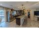 Modern kitchen with granite countertops, stainless steel appliances, and a breakfast bar at 3076 Crane Strand Dr, Winter Park, FL 32792