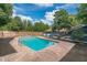 Backyard pool area surrounded by lush greenery and an expansive brick patio at 3076 Crane Strand Dr, Winter Park, FL 32792