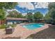 Backyard swimming pool area with brick pavers and mature landscaping at 3076 Crane Strand Dr, Winter Park, FL 32792