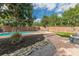 Picturesque backyard swimming pool with stone accents and lush landscaping at 3076 Crane Strand Dr, Winter Park, FL 32792