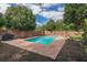 Backyard swimming pool surrounded by brick pavers and a wooden fence at 3076 Crane Strand Dr, Winter Park, FL 32792