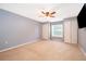 Spacious bedroom featuring carpeted floors, double closets, a ceiling fan, and natural light at 516 Yellow Tail Pl, Chuluota, FL 32766