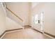 The foyer has tile floors, a stairway and glass front door at 516 Yellow Tail Pl, Chuluota, FL 32766