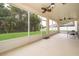 Screened-in patio with an exterior view of the green backyard at 516 Yellow Tail Pl, Chuluota, FL 32766