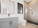 Modern bathroom with gray vanity, walk-in shower, and toilet at 5762 Emerington Cres, Orlando, FL 32819