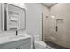 Modern bathroom with gray vanity, walk-in shower, and toilet at 5762 Emerington Cres, Orlando, FL 32819