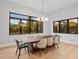 Bright dining room features a wood table with six chairs and large windows at 5762 Emerington Cres, Orlando, FL 32819