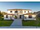 Two-story home with gray stone and white siding, paver driveway, and landscaping at 5762 Emerington Cres, Orlando, FL 32819