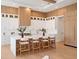 Modern kitchen with white and wood cabinetry, quartz countertops and breakfast bar at 5762 Emerington Cres, Orlando, FL 32819