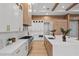 Modern kitchen with white and wood cabinets, quartz countertops, and a large island at 5762 Emerington Cres, Orlando, FL 32819