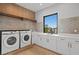 Laundry room with washer, dryer, and ample counter space at 5762 Emerington Cres, Orlando, FL 32819