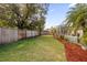 Landscaped backyard with fenced perimeter and mature trees at 1657 Carillon Park Dr, Oviedo, FL 32765