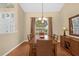 Dining area with a wooden table, chandelier, and hardwood floors at 1657 Carillon Park Dr, Oviedo, FL 32765