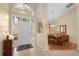 Bright and airy entryway with tile flooring and views into the dining room at 1657 Carillon Park Dr, Oviedo, FL 32765