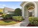 Side view showing the home's architectural details and manicured landscaping at 1657 Carillon Park Dr, Oviedo, FL 32765