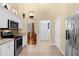 Modern kitchen with stainless steel appliances and white cabinetry at 1657 Carillon Park Dr, Oviedo, FL 32765