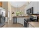 Modern kitchen with stainless steel appliances and white cabinetry at 1657 Carillon Park Dr, Oviedo, FL 32765