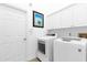 Laundry room with washer, dryer, and ample storage at 1657 Carillon Park Dr, Oviedo, FL 32765