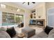 Living room with fireplace, sliding doors opening to a pool and screened patio at 1657 Carillon Park Dr, Oviedo, FL 32765