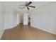 Bedroom featuring a ceiling fan, wood floors and a view to the kitchen at 2533 Grassy Point Dr # 205, Lake Mary, FL 32746