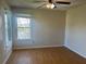 Bedroom featuring a ceiling fan, wood floors, and a window for natural light at 2533 Grassy Point Dr # 205, Lake Mary, FL 32746