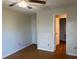 Bedroom featuring a ceiling fan, wood floors, closet access and natural light from a door at 2533 Grassy Point Dr # 205, Lake Mary, FL 32746