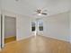 Spacious bedroom featuring wood laminate flooring, ceiling fan, and natural light from two windows at 2533 Grassy Point Dr # 205, Lake Mary, FL 32746