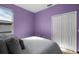 Lavender bedroom with double bed and closet at 326 Highland Meadows Ave, Davenport, FL 33837