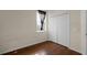 Bedroom with wood floors, window, and double door closet at 326 Highland Meadows Ave, Davenport, FL 33837