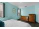 Bedroom with light teal walls, wood floors, and dresser at 326 Highland Meadows Ave, Davenport, FL 33837