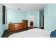 Light teal bedroom with wood dresser and large bed at 326 Highland Meadows Ave, Davenport, FL 33837