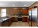 Kitchen features stainless steel appliances and wood cabinetry at 326 Highland Meadows Ave, Davenport, FL 33837