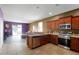 Open concept kitchen with granite countertops and stainless steel appliances at 326 Highland Meadows Ave, Davenport, FL 33837