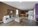 Living room with a grey sectional and kitchen access at 326 Highland Meadows Ave, Davenport, FL 33837