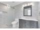 Updated bathroom with gray vanity, marble tile, and glass shower door at 733 Preble Ave, Altamonte Springs, FL 32701