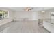 Spacious living room with light gray vinyl plank flooring and a marble accent wall at 733 Preble Ave, Altamonte Springs, FL 32701