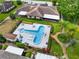 Aerial view of pool area, grounds, and roofline of a well maintained building at 10 Pilot Pl, Winter Haven, FL 33881