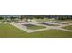Aerial view of airfield with planes parked on a grassy field near the airport building at 10 Pilot Pl, Winter Haven, FL 33881