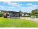 Spacious backyard with covered patio, seating area, and lush green lawn at 10 Pilot Pl, Winter Haven, FL 33881