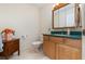Functional bathroom featuring a vanity with a framed mirror, toilet, and drawers at 10 Pilot Pl, Winter Haven, FL 33881