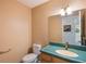 This bathroom features a wood vanity with lots of storage, a toilet, and a large wall mirror above the sink at 10 Pilot Pl, Winter Haven, FL 33881