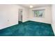 Bright bedroom with carpet, white walls, and an ensuite bathroom at 10 Pilot Pl, Winter Haven, FL 33881