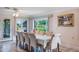Bright dining room with large windows and a dining table with seating for eight at 10 Pilot Pl, Winter Haven, FL 33881