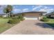 Brick driveway leading to a white garage door at 10 Pilot Pl, Winter Haven, FL 33881